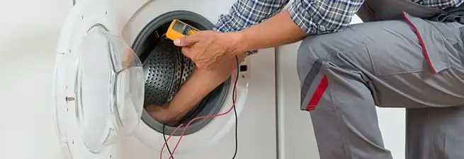 Dryer repair technician inspecting and repairing a clothes dryer in Naperville, IL