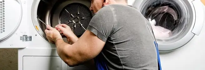 Dryer repair technician fixing a clothes dryer drum in Naperville, IL