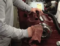 Vacuum repair technician cleaning and servicing a vacuum motor in Naperville, IL