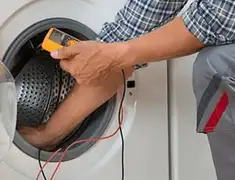 Washing machine repair technician testing a front-load washer with diagnostic tools in Naperville, IL
