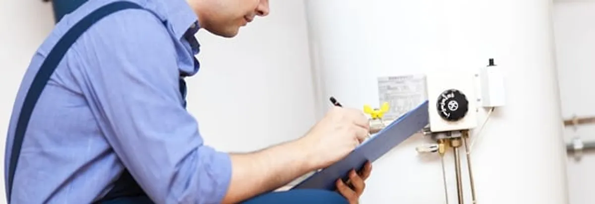 Water heater repair technician inspecting the unit and recording service notes in Naperville, IL
